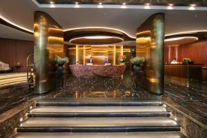 a lobby of a hotel with stairs leading to a reception at MAY DE VILLE Corner Hotel in Hanoi +87 photos