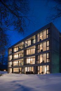 a large building with many windows at night at Kozue in Niseko