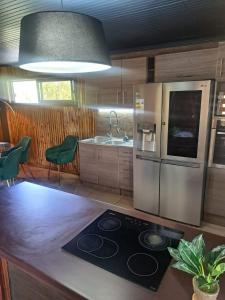 a kitchen with a stove and a refrigerator at Casa campo in Puerto Varas
