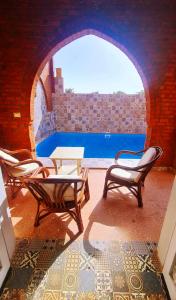 a patio with chairs and a table and a pool at Luxor Tower in Luxor