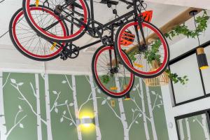 two bikes hanging from the ceiling in a room at Studio Loft Apartment w bikes Wifi CBD in Auckland +2 photos