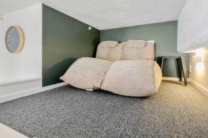 a large couch sitting in a corner of a room at Studio Loft Apartment w bikes Wifi CBD in Auckland