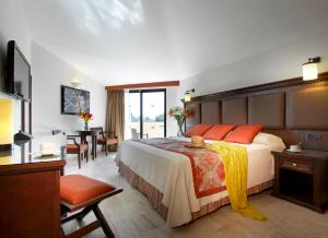 a hotel room with a large bed and a table at Grand Palladium Vallarta Resort & Spa - All Inclusive in Punta Mita