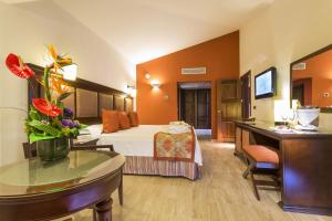 a hotel room with a bed and a desk at Grand Palladium Vallarta Resort & Spa - All Inclusive in Punta Mita