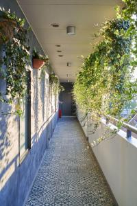 a hallway with plants on the side of a building at Hotel Tokyo Trip Ueno Nishi Nippori in Tokyo