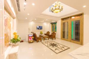 a large living room with a chandelier at The Airport Hotel in Ho Chi Minh City