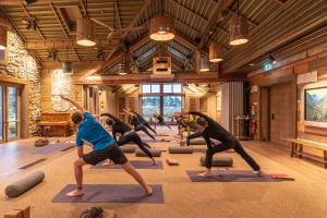 a group of people in a yoga class in a room at Headwaters Glenorchy Eco Lodge in Glenorchy