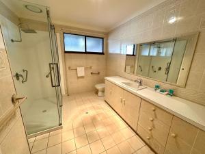 a bathroom with a shower and a sink and a toilet at Bignell Family Home-Stay in Broadwater +28 photos