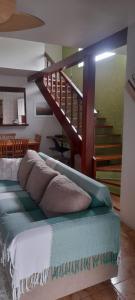 a bedroom with a bed with a staircase in the background at Casa Ilhabela in Ilhabela