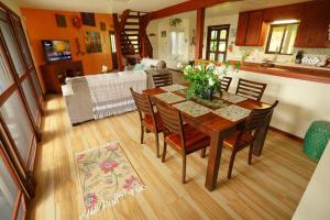 a dining room table and chairs in a living room at kehena black sand beach house - ocean view swim spa in Pahoa