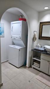a white refrigerator in a kitchen with a sink at Solarium Studio Apartment at Coronado Bay Oceanfront in Playa Coronado