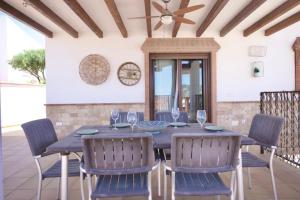 un tavolo da pranzo con sedie blu e un soffitto di Casa Carmen a Nerja