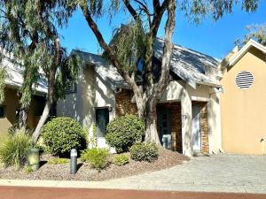 a house with a tree in front of it at SeventyThree at Cape View Resort in Broadwater