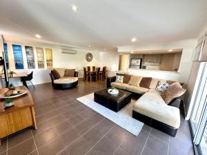a living room with a couch and a table at SeventyThree at Cape View Resort in Broadwater