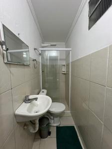 a bathroom with a sink and a toilet at Boas Vindas in Guarujá