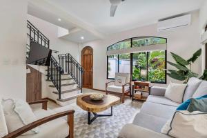 a living room with a couch and a table at Pool Oasis, Concierge & 5min drive to the Beach in Playa Flamingo