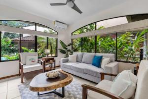 a living room with a couch and a table at Pool Oasis, Concierge & 5min drive to the Beach in Playa Flamingo