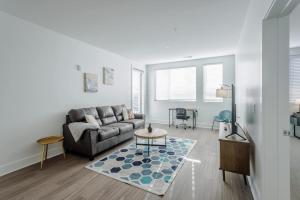 a living room with a couch and a table at Cozysuites l Luxe 2BR in Downtown Cincinnati #2 in Cincinnati