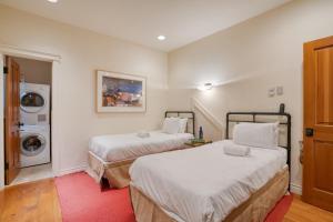 a room with two beds and a washing machine at Manitou River House 113 by AvantStay A Location in Telluride