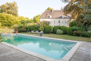 a swimming pool in front of a house at Domaine Labattut in Saint-Astier