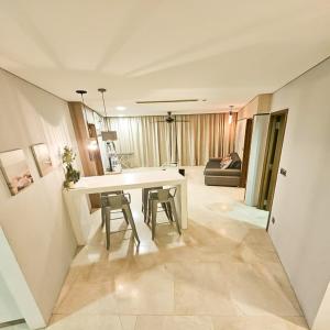 a kitchen and living room with a table and chairs at Vortex klcc by hr in Kuala Lumpur
