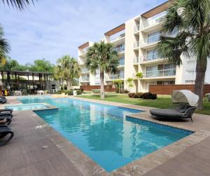 a swimming pool in front of a building at Vibe Gorgeous one bedroom apartment view beach in La Laguna