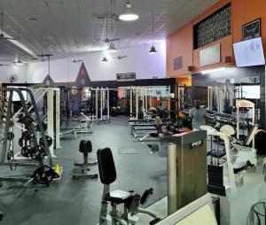 a gym with a lot of equipment and people in it at Vibe Gorgeous one bedroom apartment view beach in La Laguna