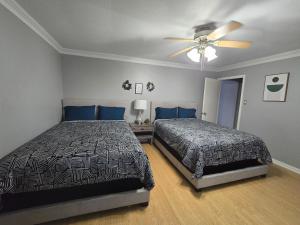 a bedroom with two beds and a ceiling fan at HoustonGem Private Pool & Hot Tub 20 Min to DT in Houston +62 photos