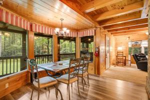 a dining room with a table and chairs at Twin Creeks Lodge by AvantStay 33 Acre Retreat in Brevard