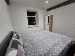 a bedroom with a bed and a window at Canalside Period Conversion in Burnley