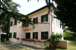 a white house with flowers in front of it at Villa Crispi in Mestre