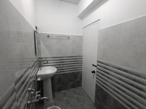 a bathroom with a sink and a toilet in it at Tersha Homestay 2BHK in Shillong +18 photos