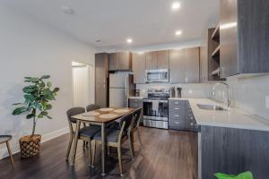 a kitchen with a table and chairs in a kitchen at Cozysuites l Luxe 2BR in Downtown Cincinnati #4 in Cincinnati +18 photos