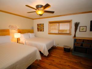 a bedroom with two beds and a ceiling fan at The Resort at Schlitterbahn in New Braunfels