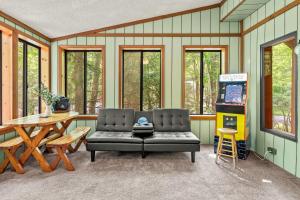 a living room with a couch and a gas pump at Deer Hollow by AvantStay Big Yard Lake Access in Albrightsville