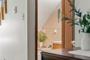 a bathroom with a sink and a shower with plants at Deer Hollow by AvantStay Big Yard Lake Access in Albrightsville +25 photos