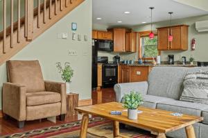 a living room and kitchen with a couch and a table at Otter Banks by AvantStay Sleeps 18 Hot Tub Views Game Room in Albrightsville