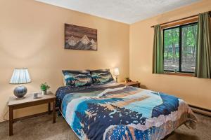 a bedroom with a bed and a window at Hygge Home by AvantStay Deck for Outdoor Living Fire Pit Game Table in Blakeslee