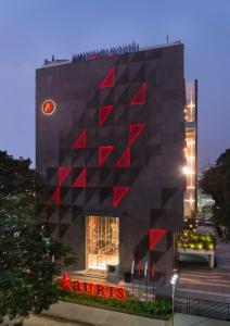 a building with a red sign in front of it at Aauris in Kolkata