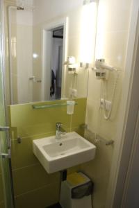 a bathroom with a sink and a mirror at Hotel Centrum Brno in Brno