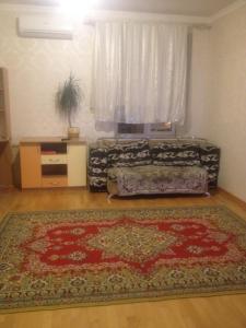 a living room with a rug on the floor at Apartment Na Gazone in Velikiy Novgorod