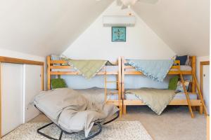 a room with bunk beds in a attic at Sisters by the Sound by AvantStay Beach Access in Coupeville