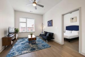 a living room with a bed and a couch at Stunning Nulu 1BR CozySuites 07 in Louisville