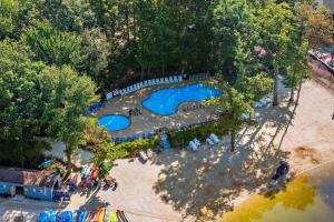 an overhead view of a park with two blue pools at Highland Hideaway by AvantStay Group Poconos Retreat w Patio Game Room in Lake Harmony