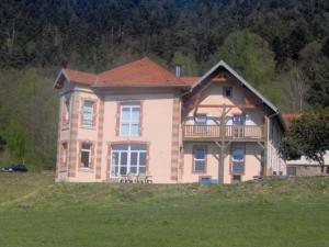 a large house with a balcony on top of a field at Chambre Jonquille - 3 Pers, Nature et Confort - FR-1-589-730 in Moyenmoutier +9 photos