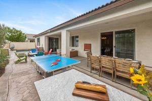 a patio with a blue table and chairs at Kaleidoscope by AvantStay Colorful Escape Pool in Indio