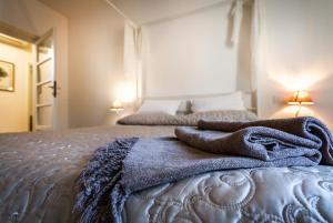 a bedroom with a bed with a blanket on it at Regina 24 in Cernobbio