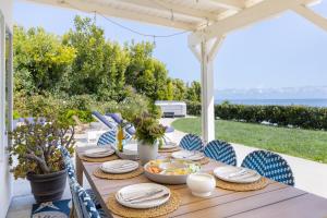 a table with plates and bowls of food on a patio at Stardust by AvantStay Views Hot Tub Pool Table in Malibu