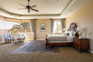 a bedroom with a bed with a ceiling fan at Sangiovese By AvantStay Spectacular Estate w Pool Hot Tub Putting Green in Temecula +96 photos