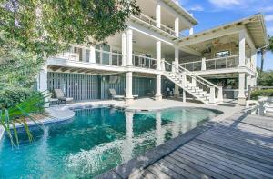 a house with a swimming pool in front of a house at 3100 Palm Boulevard by AvantStay Beachfront Ocean Views Private Pool in Isle of Palms